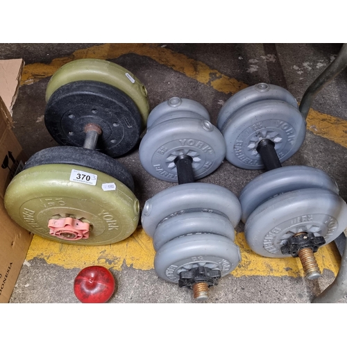 370 - Three bar bells with 14 weight discs ranging from 1lb to 1.25kg.