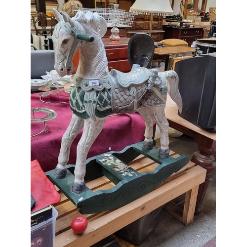 382 - Star lot : A very charming wooden rocking horse boasting great detail and floral appliques. This is ... 