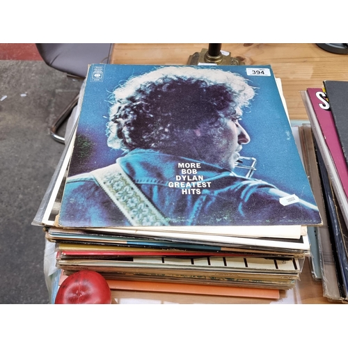 394 - A collection of approx. 33 LP vinyl records including artists Bob Dylan, Billy Joel and Paul Simon.