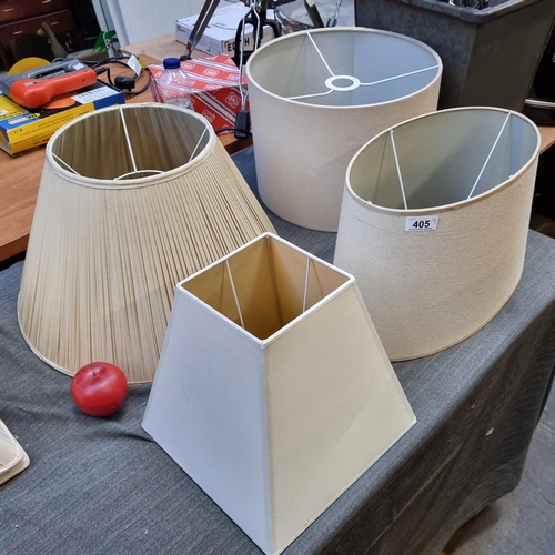 405 - Four stylish cream lamp shades in various shapes.