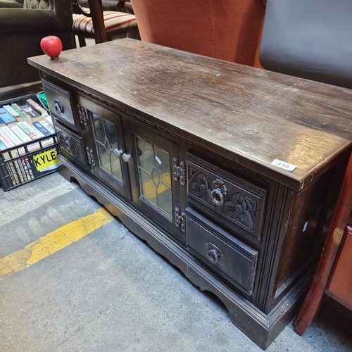 418 - A great example of a vintage sideboard featuring astraglazed glass doors to reveal a shelf, and four... 