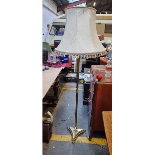 421 - An elegant floor standing lamp with a brass base with lion paw feet and large cream shade. Would ben... 