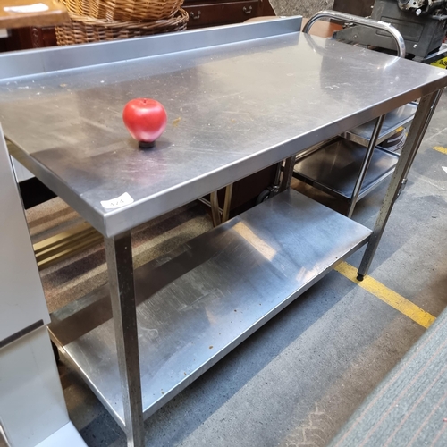 424 - A commercial Stainless Steel kitchen prep table made from stainless steel. With gallery back and she... 