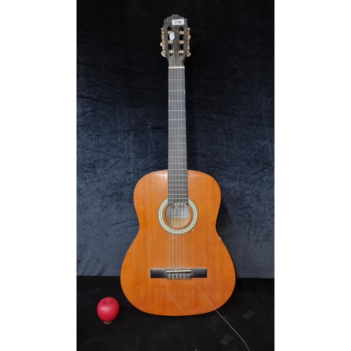 776 - A Messina acoustic classical guitar model 74427. In black and brown colourway.