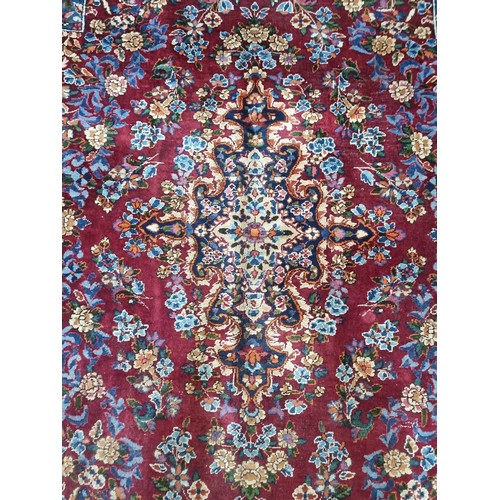 902 - Star Lot: A magnificent and large hand woven Persian style woolen rug, boasting an intricate foliate... 