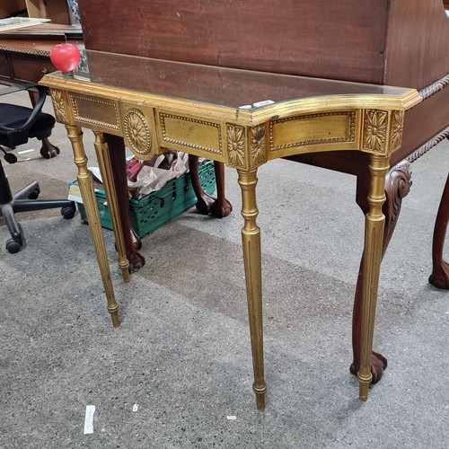 834 - Star lot : An ornate console table with a mirrored top, held on stylish tapered reeded legs, featuri... 