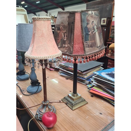 397 - Two ornate table lamps including an example with a shade featuring various scenes.