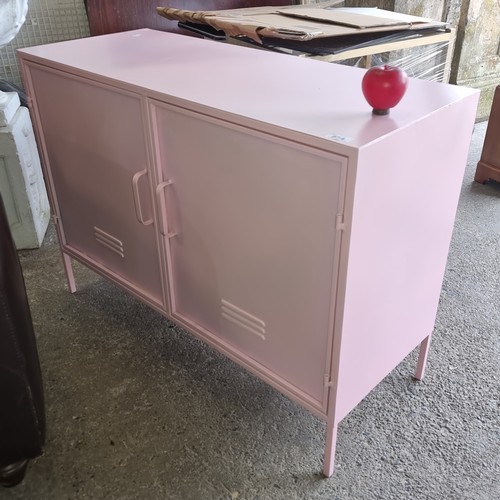 854 - A striking baby pink metal sideboard with doors to reveal a full length shelf. H72cm x W100cm x D40c... 