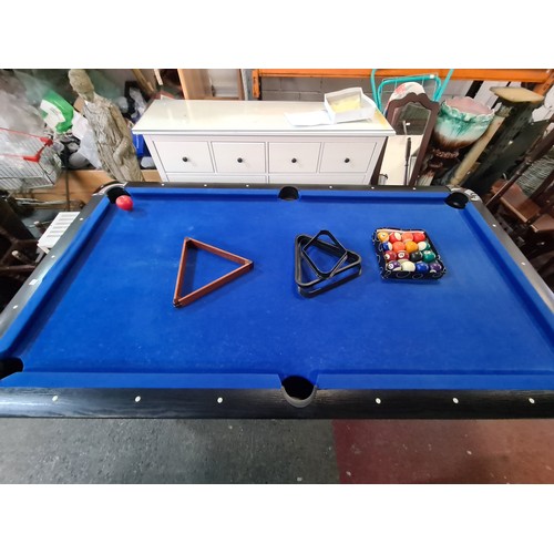 842 - A 6 x 3ft. feet Wooden pool table with black ash wood surround. With a full set of pool balls and 2 ... 