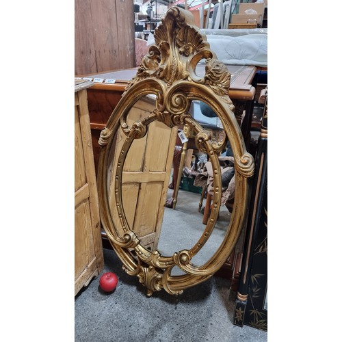 680 - Star Lot : A very impressive lavish wall mirror held in an ornate gilt frame boasting fluid organic ... 