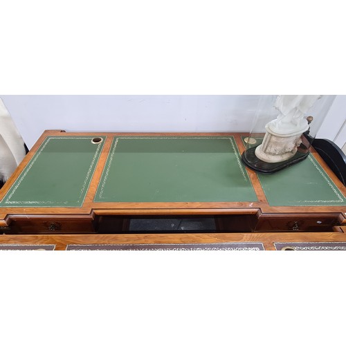 688 - Star Lot : A monumental large Directors desk featuring a green tooled leather top in three parts, wi... 