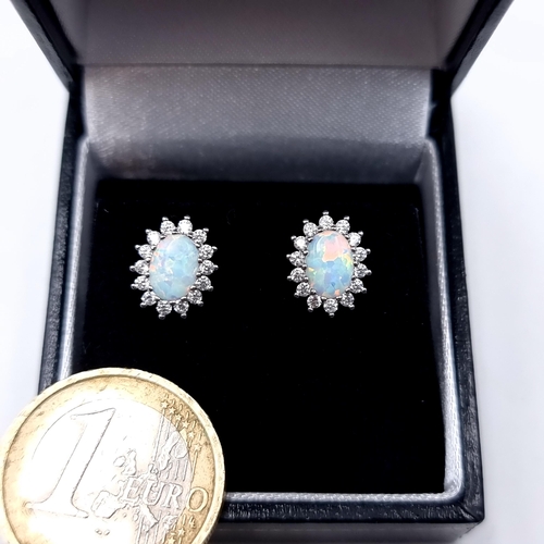 870 - A pair of Opal stone stud earrings set in sterling silver with white sapphire surround, old new stoc... 