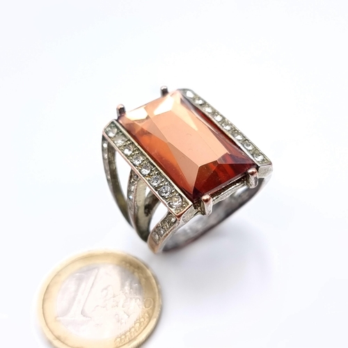 877 - A statement ring of Morganite stone with gem set surround, size P, weight 11.35 grams, boxed.