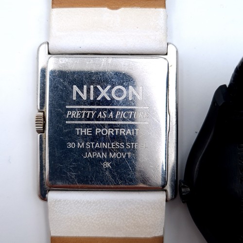 446 - A Nixon stainless steel leather strap wristwatch together with a Swatch water resistant example.