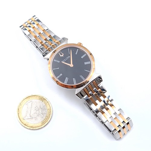 450 - Star Lot : A mid size Bulova ladies wristwatch set with black face Roman Numeral dial and gold metal... 