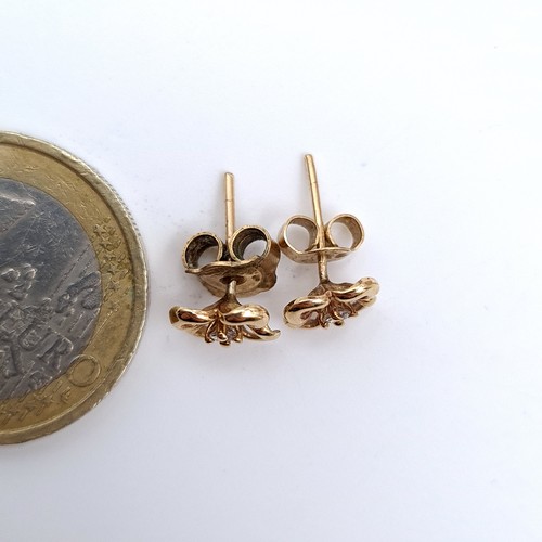 452 - A pair of 9K gold stud earrings set with diamond stone accents, total weight 1 gram.