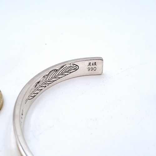 458 - A high grade silver bracelet with leaf design to inner band set with a love inscription. Weight 23.6... 