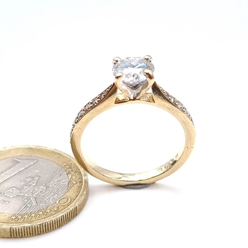 476 - Star Lot : A fine example of a moissanite solitaire ring set in 9K gold (375) with diamond set shoul... 