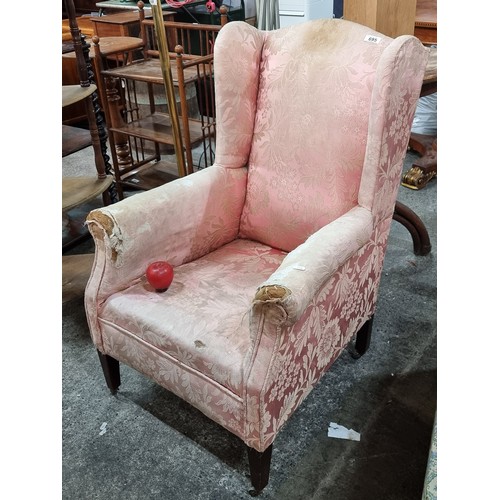 695 - Star Lot : A charming Edwardian wingback armchair. Held on original castors. With pink damask uphols... 