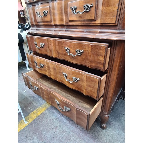 566 - Star Lot : An extravagant serpentine-front chest on chest with six full length drawers. H138cm x W99... 