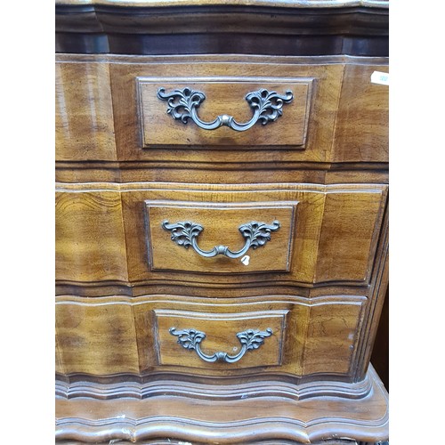 566 - Star Lot : An extravagant serpentine-front chest on chest with six full length drawers. H138cm x W99... 