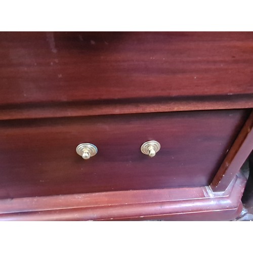 573 - An elegant dresser with four full-length drawers featuring brass swan neck handles. SD to drawer.