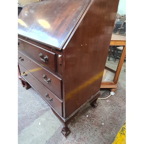 576 - A handsome vintage bureau with a drop down desk to reveal pigeon holes and correspondence drawers. F... 