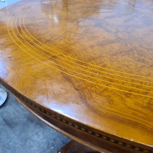 689 - Star Lot : A stunning and large Satinwood  round table with string inlay, marquetry and parquetry to... 