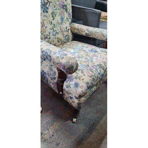 586 - A wonderful early 20th Century armchair boasting turned legs and sat on castor wheels. Upholstered i... 