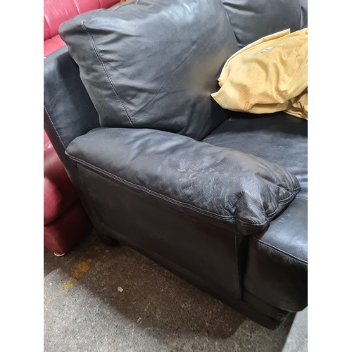 638 - A sleek and extremely comfortable black leather two seater sofa.