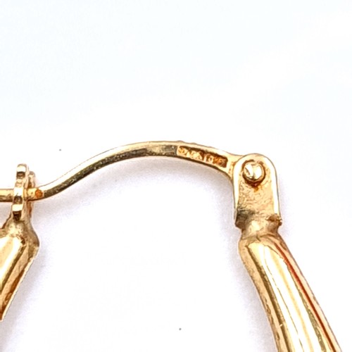 498 - A pair of 9K gold hooped earrings suitable for pierced ears.