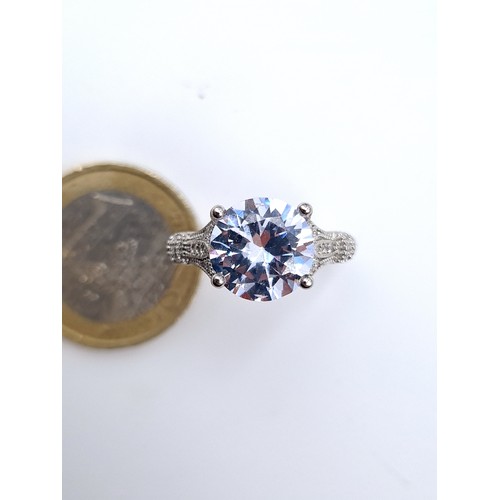 874 - A super gem stone solitaire ring with gem set mount set in sterling silver, ring size O, weight 3.44... 