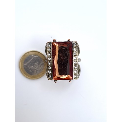 877 - A statement ring of Morganite stone with gem set surround, size P, weight 11.35 grams, boxed.