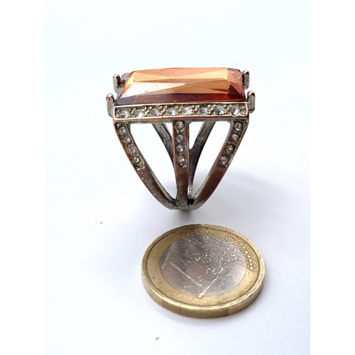 877 - A statement ring of Morganite stone with gem set surround, size P, weight 11.35 grams, boxed.