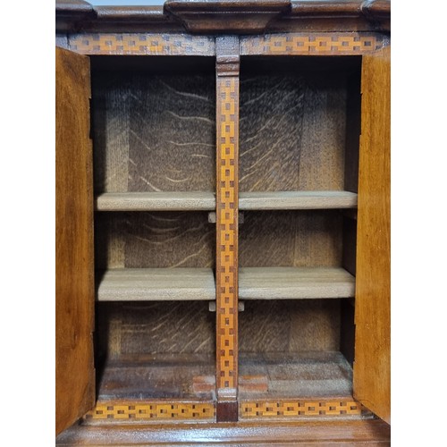 277 - A fabulous vintage counter / table top wooden cabinet featuring two doors to front opening to reveal... 