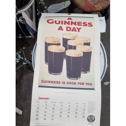 122 - A super retro Guinness branded wall calendar dating to 1996 featuring advertising heritage throughou... 