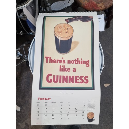 122 - A super retro Guinness branded wall calendar dating to 1996 featuring advertising heritage throughou... 