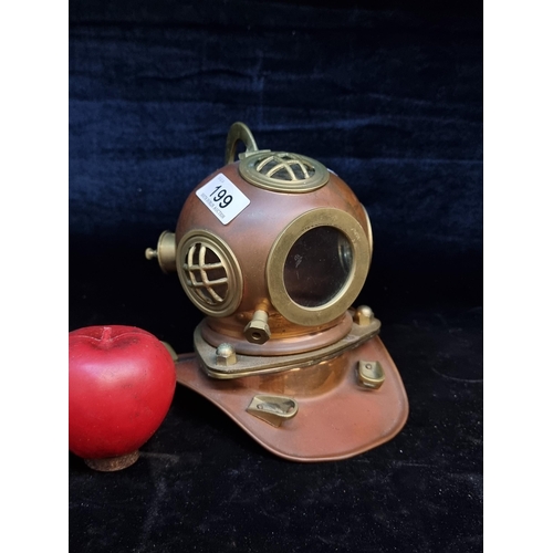 199 - An interesting desktop item in the form of a copper and brass nautical diving helmet. Not true to si... 