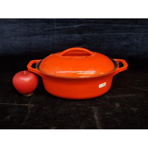 202 - A vintage very heavy cast iron Colorcast Waterford Ireland dutch oven with lid and handles in an ora... 