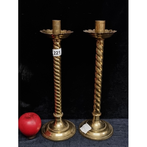 221 - A fantastic pair of antique church brass barley twist candle sticks. With petal style wax catchers.