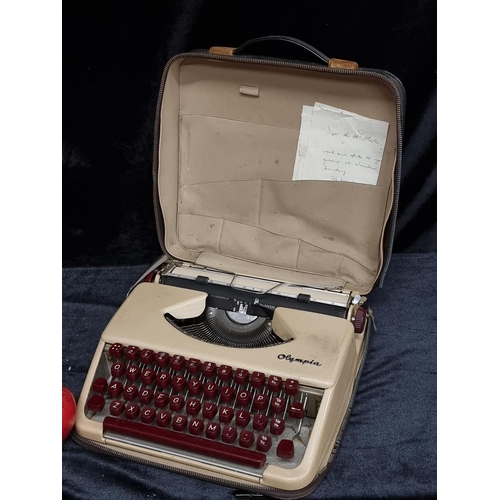 254 - A vintage Olympia typewriter in a cream and maroon colourway. With original carry case.