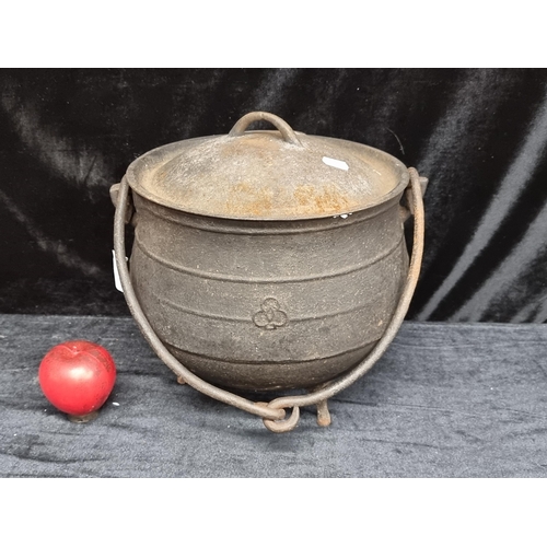 279 - An antique Victorian cast iron belly cauldron pot. A heavy piece with original lid and handle. Clove... 