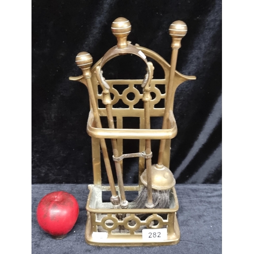 282 - A charming brass fireside companion set with poker, tongs and brush.