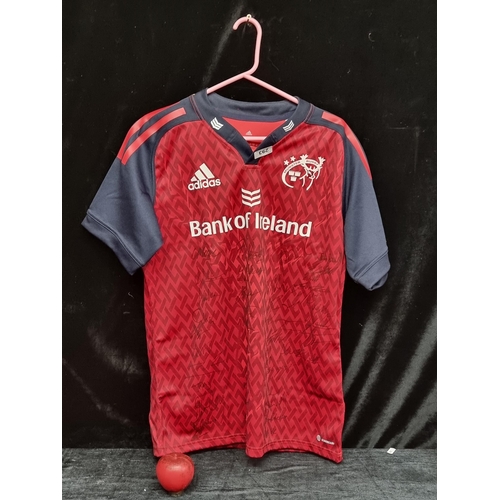 293 - A signed Adidas Munster Home rugby shirt in size large. Features signatures from the squad including... 