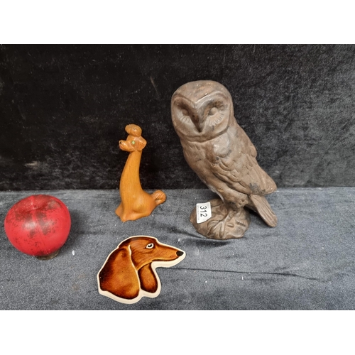 312 - A trio for animal lovers including a cast barn owl figure, a long necked Chinese dog and a charming ... 