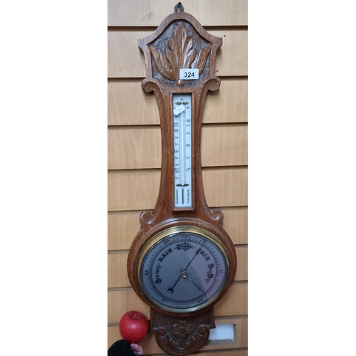 324 - A handsome antique banjo  barometer housed in a hand carved oak case.