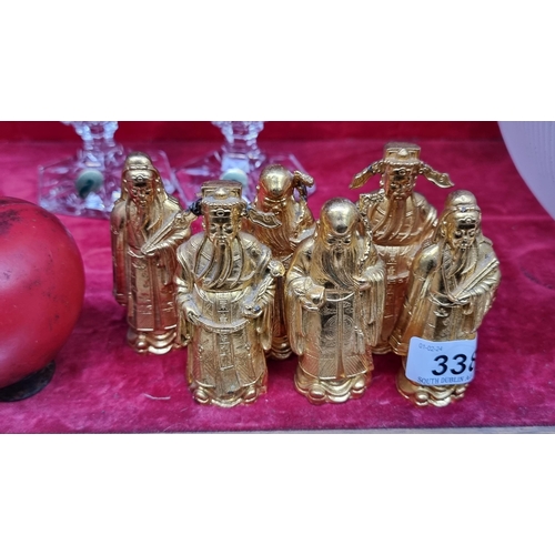 338 - A collection of six heavy brass toned figures depicting wise Chinese men.