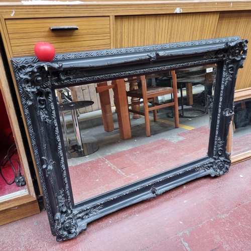 349 - A fabulous large beveled mantle mirror housed in a highly ornate goetic style frame.