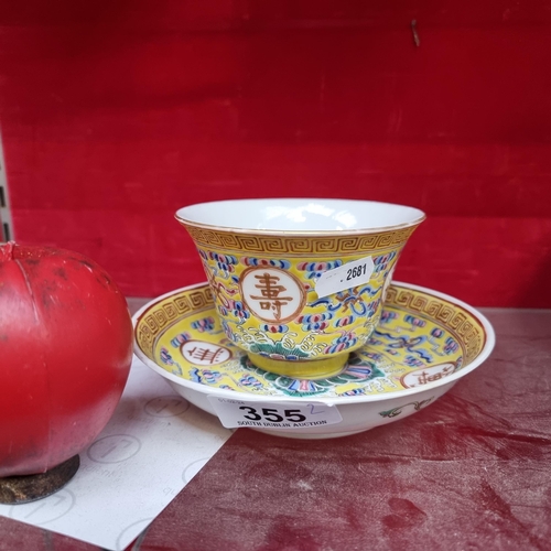 355 - A wonderful early 20th century Chinese teacup and saucer set in an attractive yellow glaze with intr... 