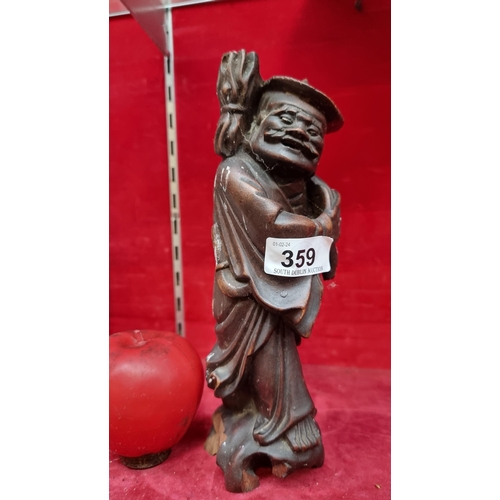 359 - A 19th century wooden carved sculpture depicting a Chinese traveler slight loss to base.